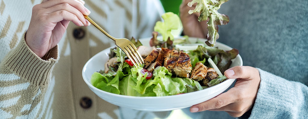 Two woman eating salad