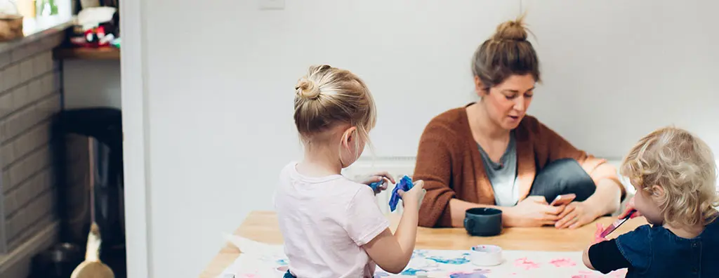 Mother with two kids painting