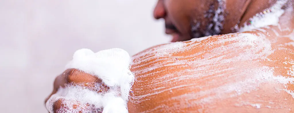 Man soaps himself in the shower