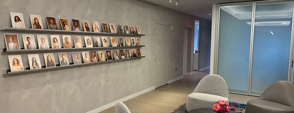 Reception area with a wall portraying all perfumers