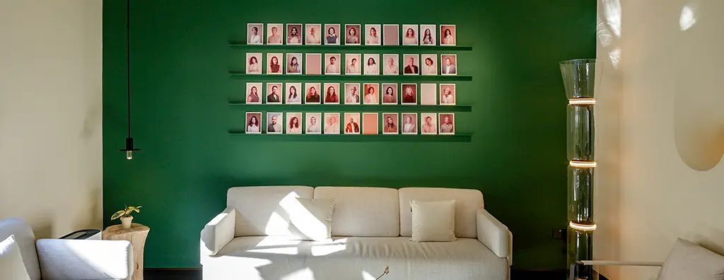 Reception area with a wall portraying all perfumers