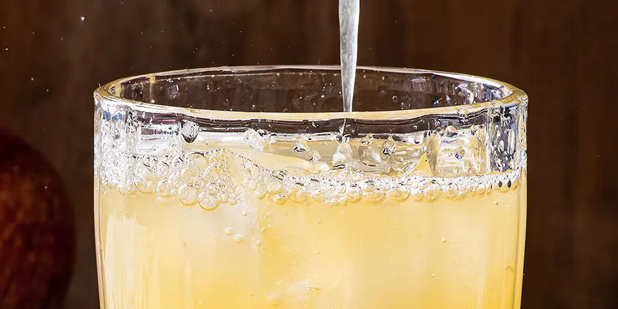 Pooring apple juice in a glass