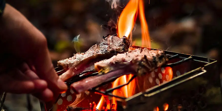 Meat being grilled on a fire