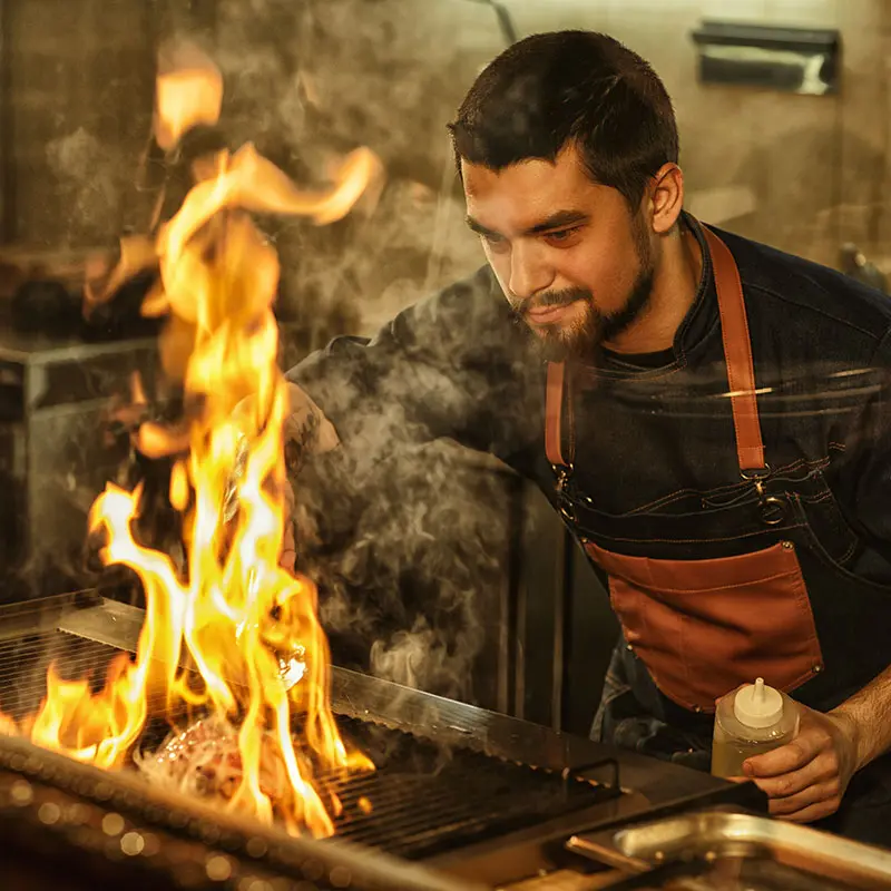 Man grilling meat on a barbecue