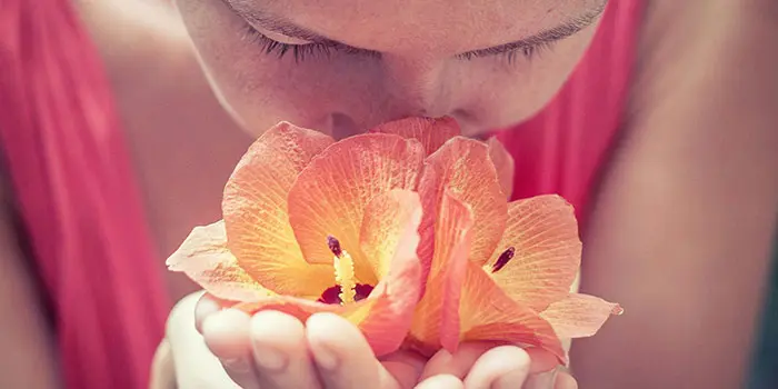 Woman smelling flowers that are in her hands
