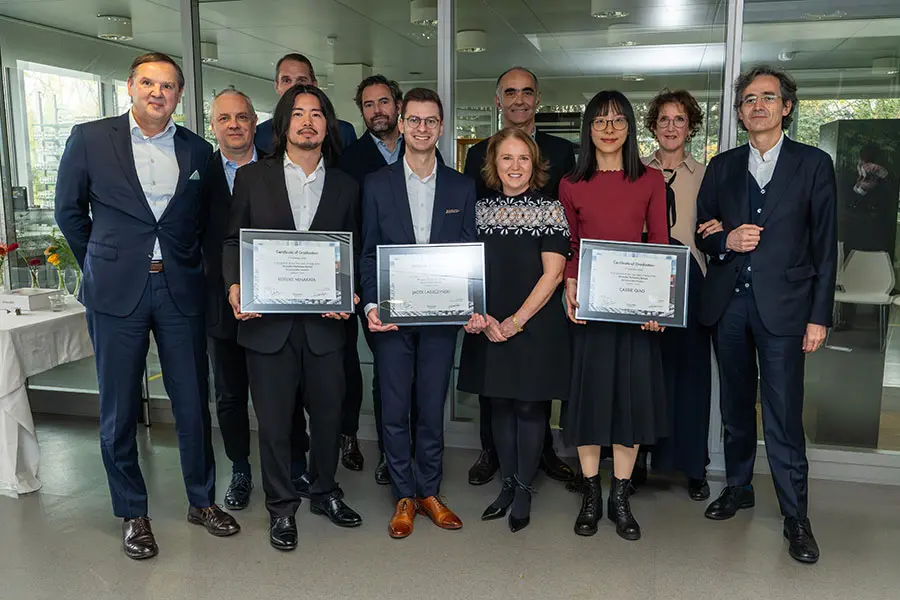 The three graduates with their awards