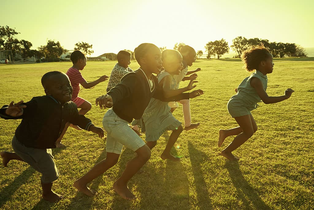 Children running during sunset