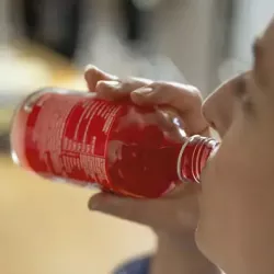 Drinking a beverage from a bottle