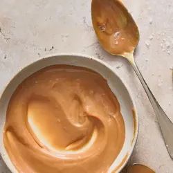 A bowl of peanut butter and spoons