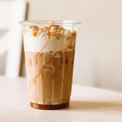 A cup of coffee with whipped cream and caramel