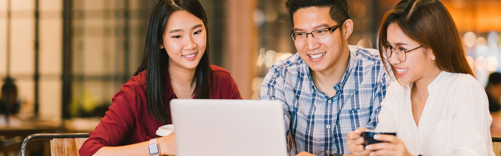 Young people around a laptop