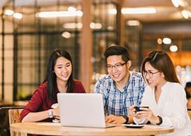 Young people around a laptop