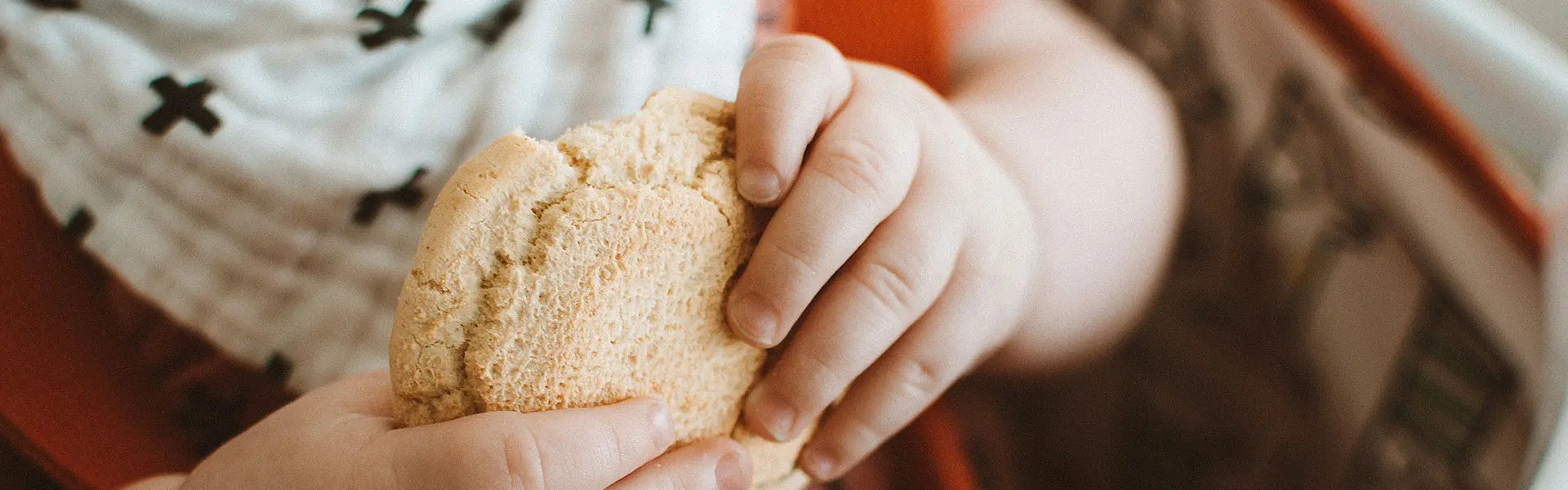 Child holding bread crust