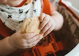 Child holding bread crust