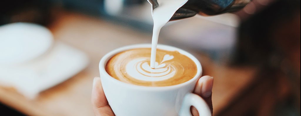 Pouring milk into coffee