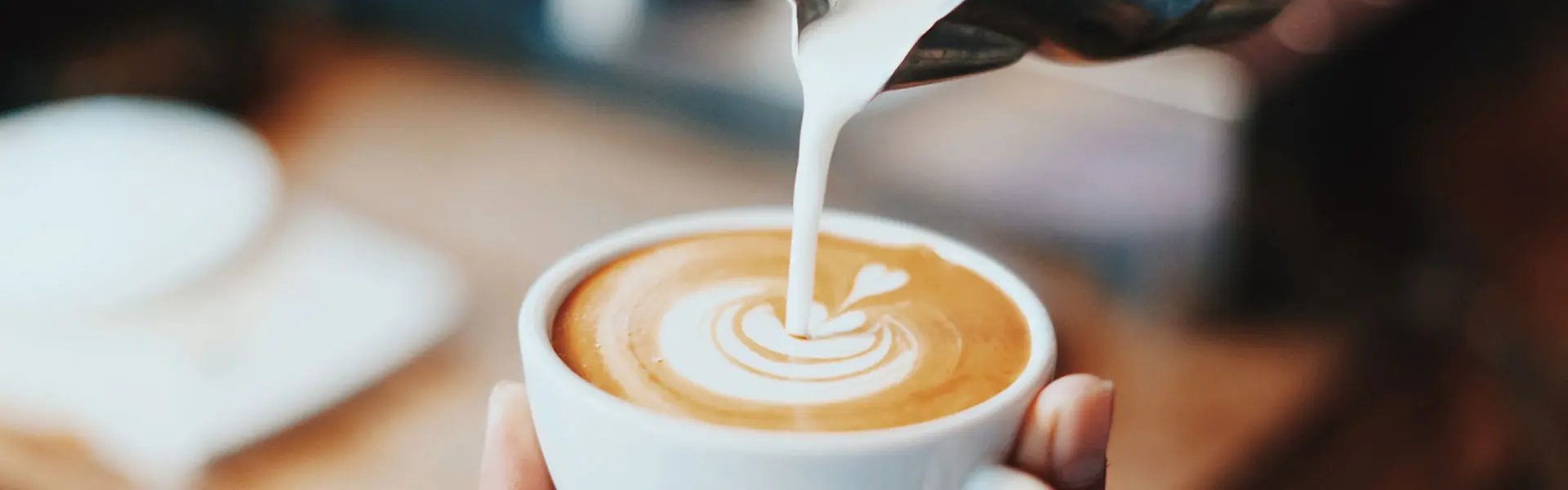 Pouring milk into coffee