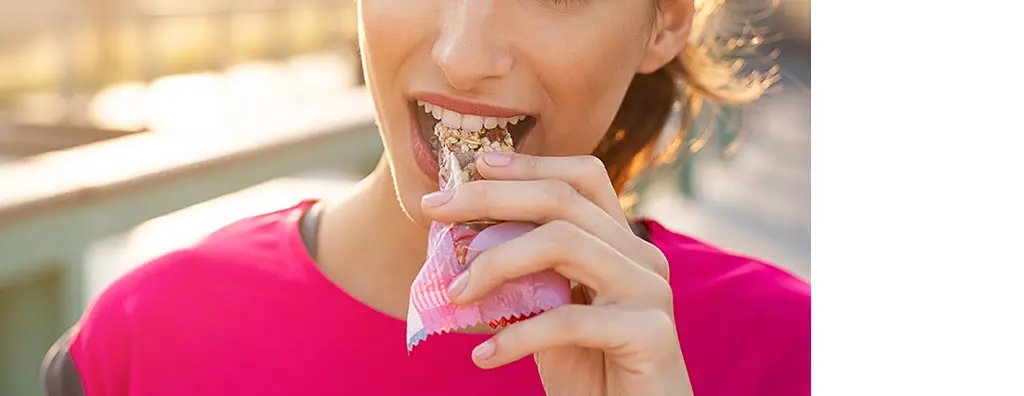 Woman eating cereal bar