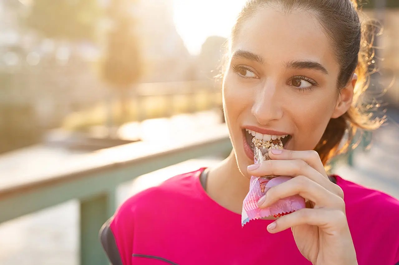 Woman eating cereal bar