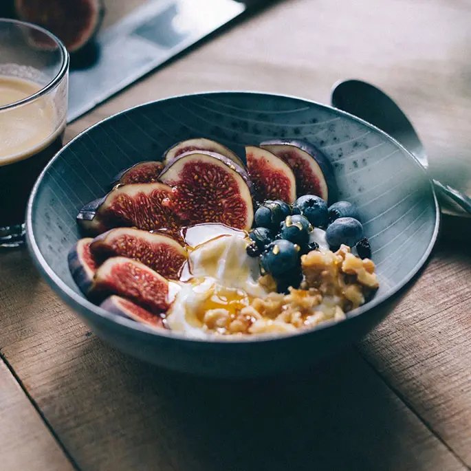 Billberries in bowl with figs and yoghurt