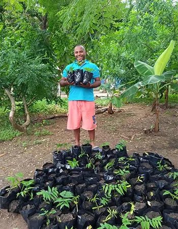 Man with tree saplings