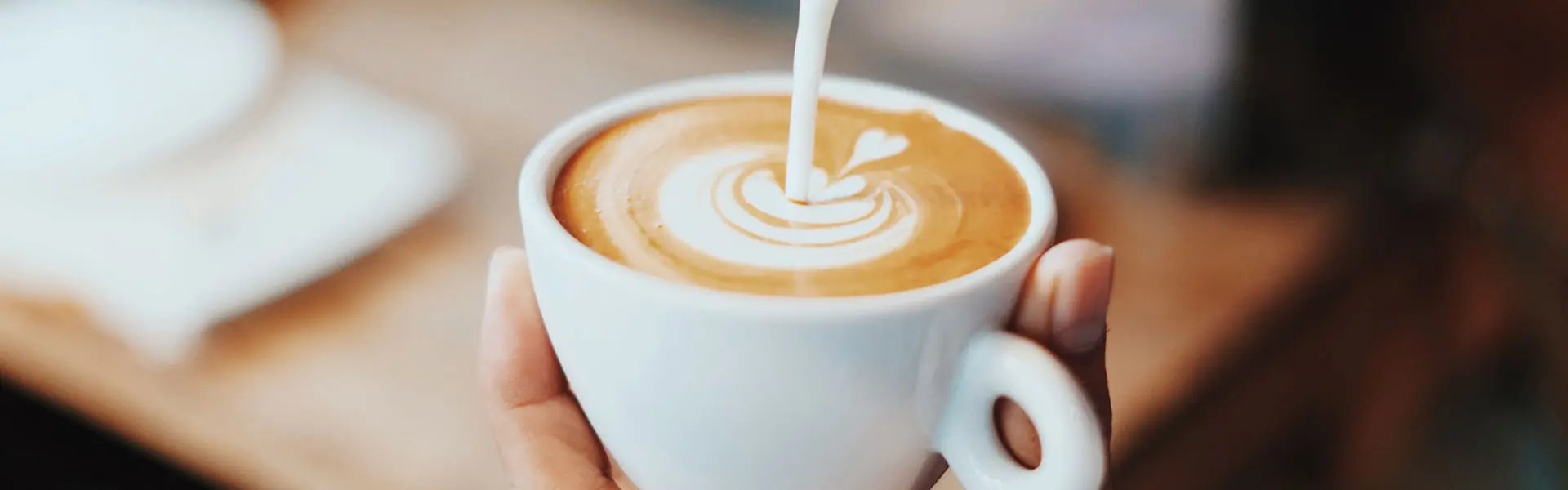 Pouring milk in coffee