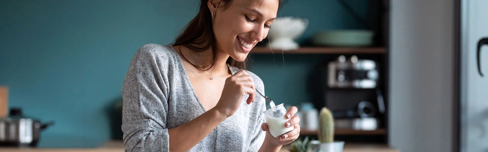 Woman eating vanilla yoghurt