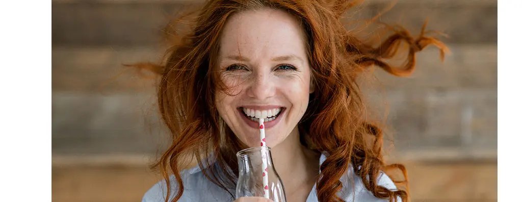 Young woman sipping a drink