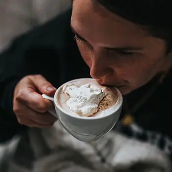 Sipping foaming cappuccino