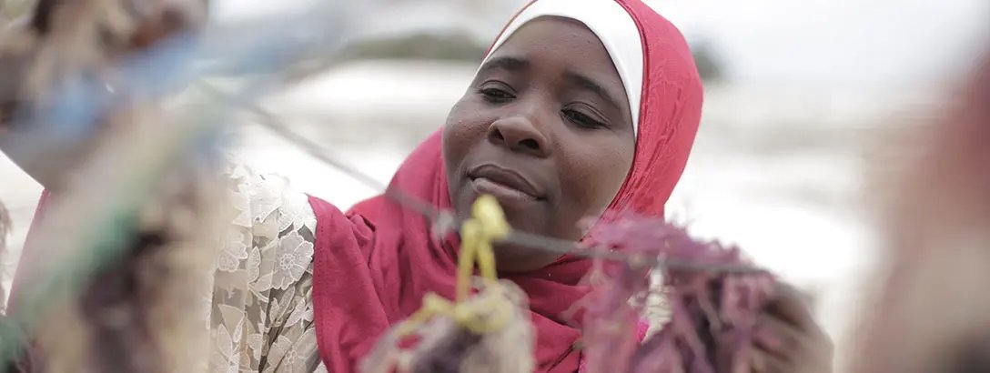 Woman working on fishing nets