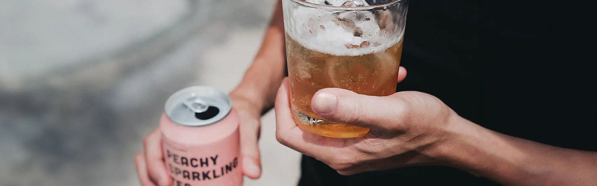 Holding a peachy sparkling tea