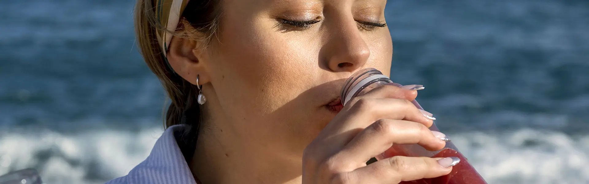 Young woman drinking a smoothie