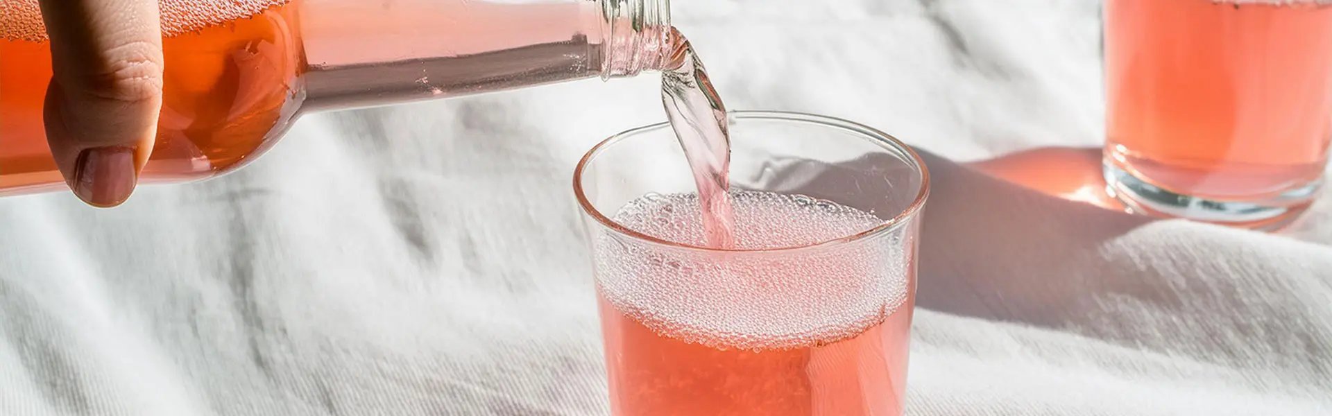 Pouring a coloured beverage in a glass