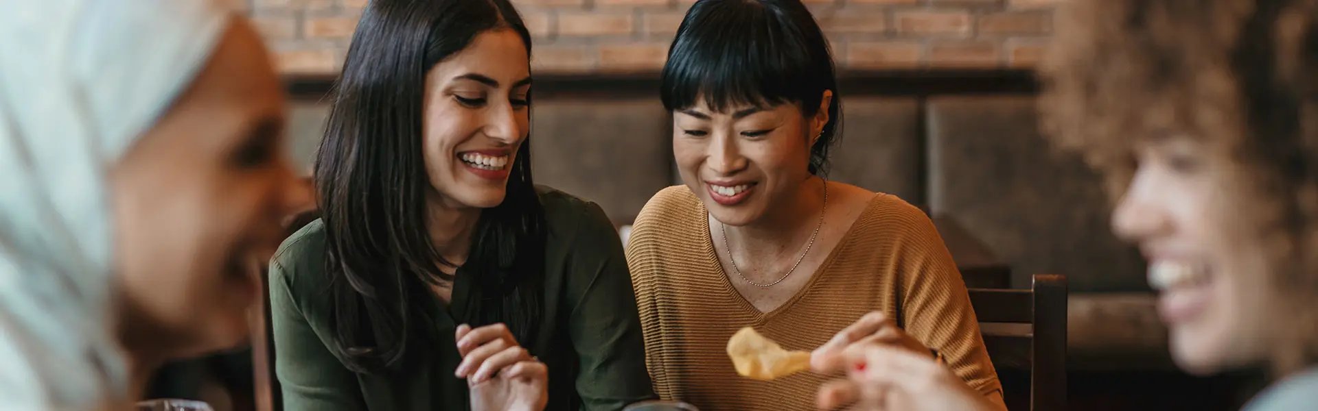 Young happy people having lunch together