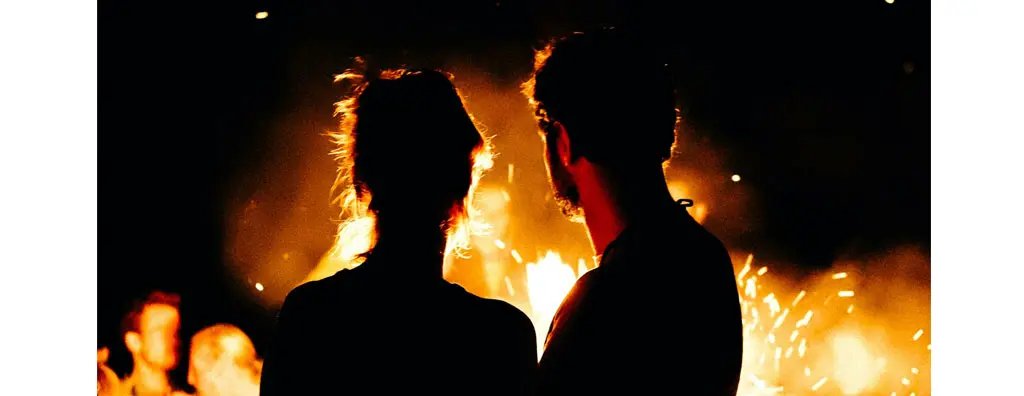 Two people looking at an open fire