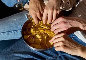 Enjoying crisps with friends