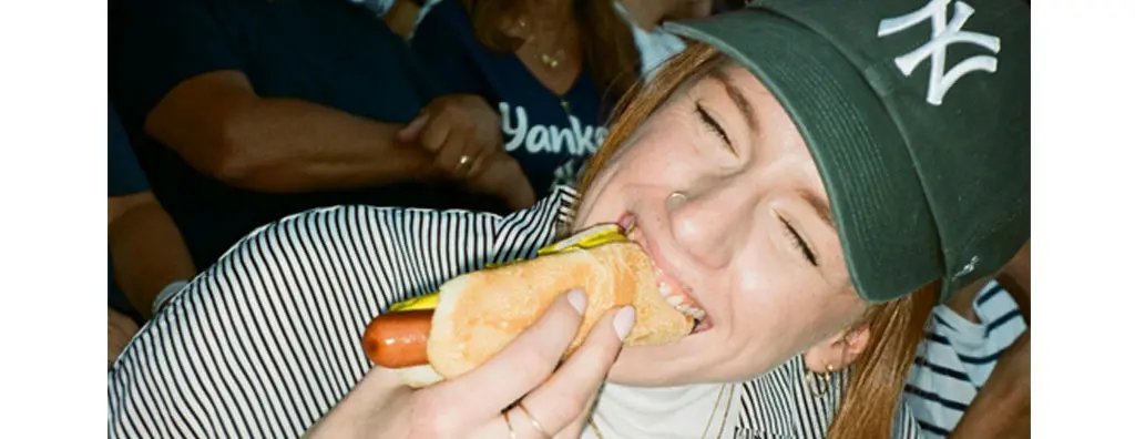 Girl eating a hot dog