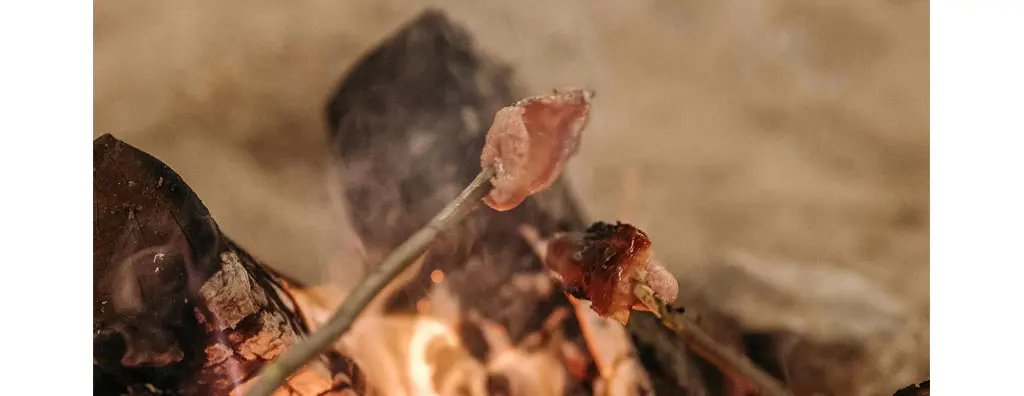 Grilled bacon over an open fire