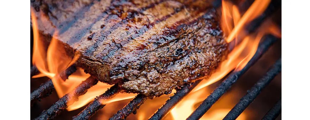 A piece of meat on a grill
