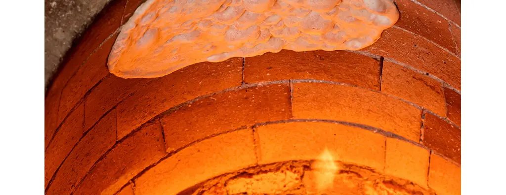 A brick oven with a fire