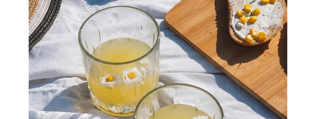 Two glasses of ice teas with flowing flowers