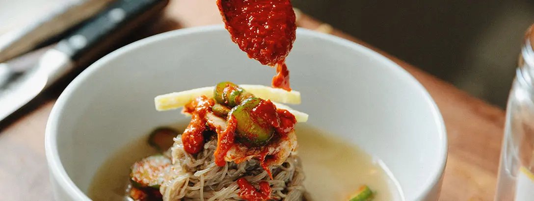 Red sauce poored over a dish
