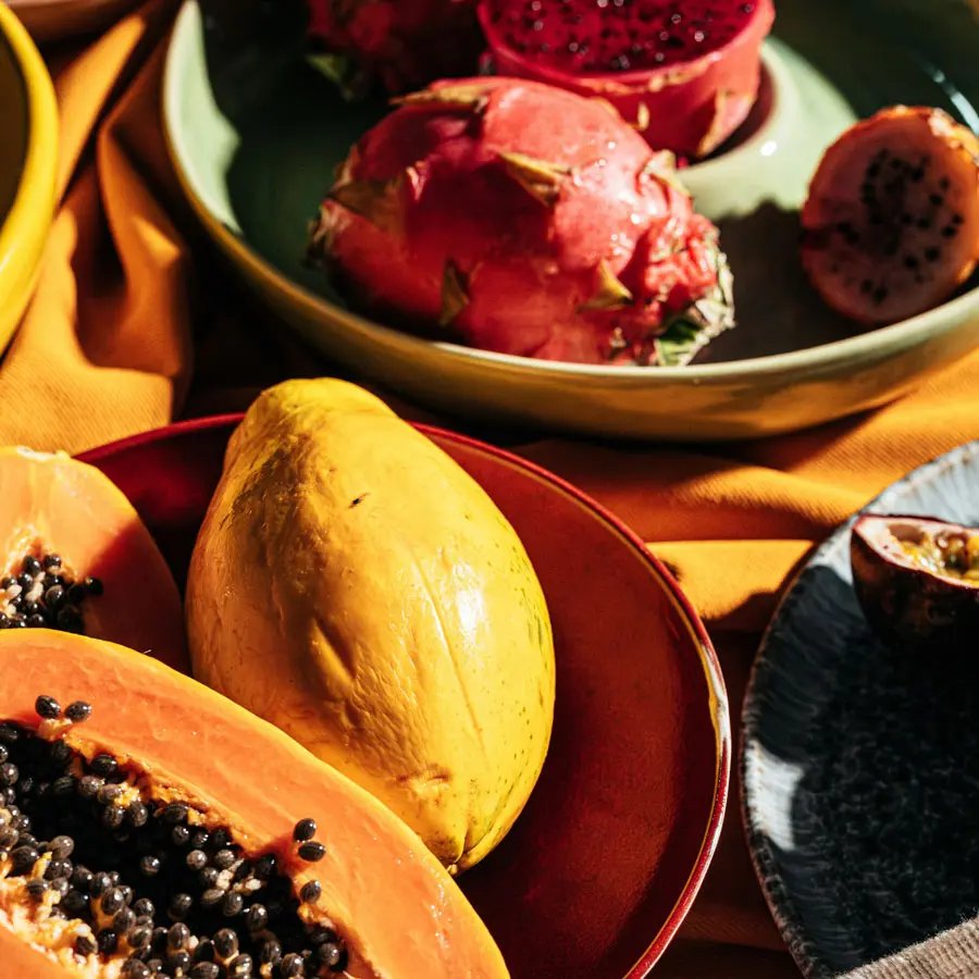 Plates with papaya and dragonfruit