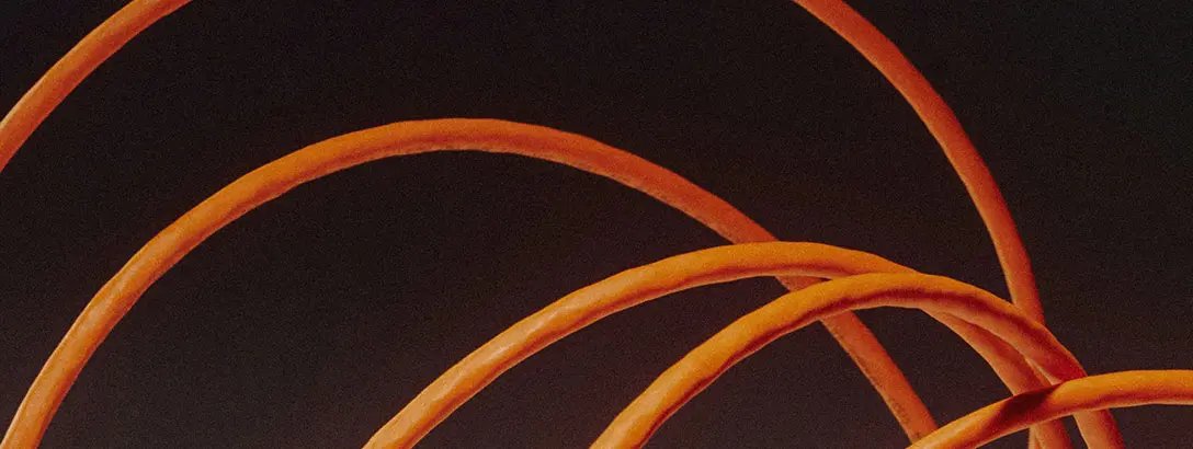 Close-up of orange internet cables on a black background