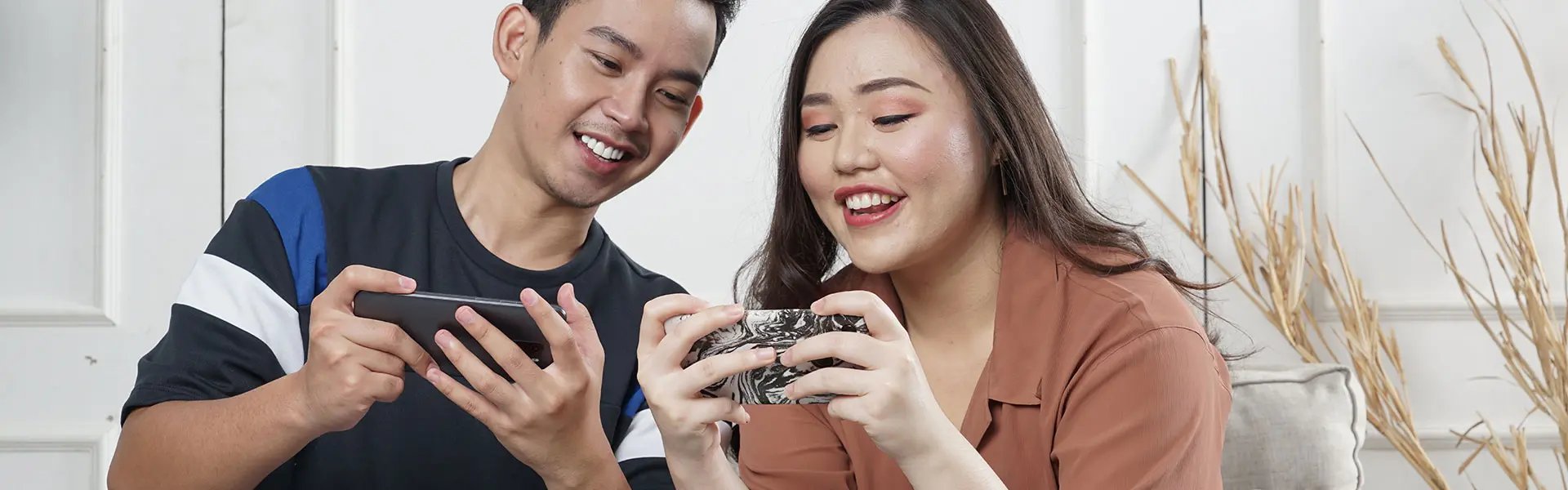 Young couple watching their mobile phones