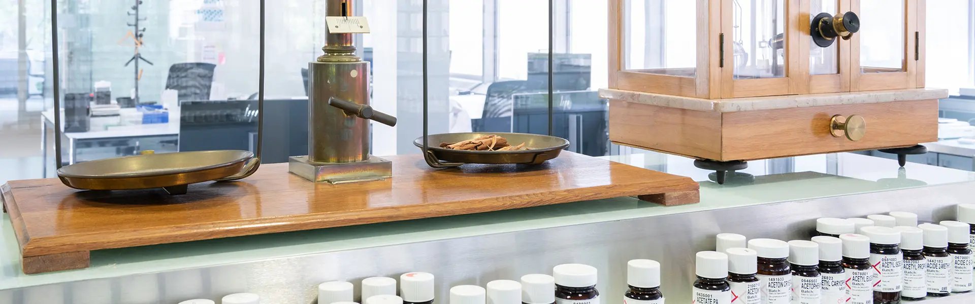 Perfumery creation space with a weighing scale and small bottles of fine fragrance ingredients