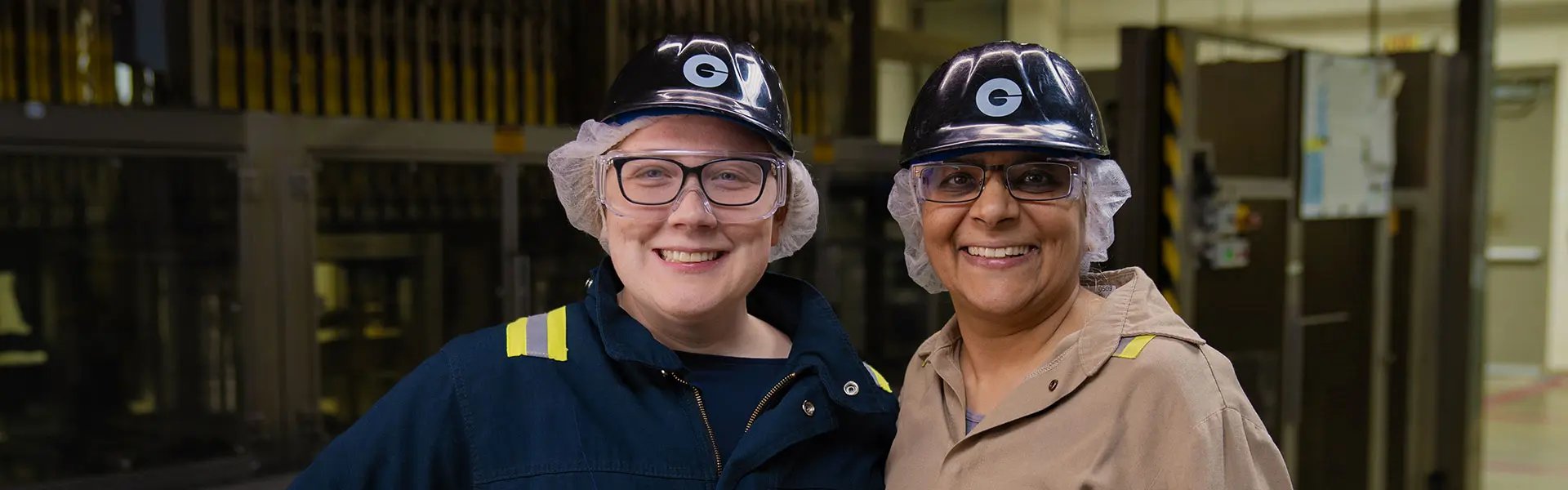 Two Givaudan employees wearing personal protective equipment (PPE)