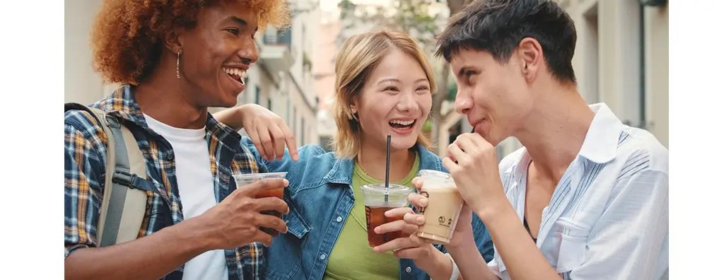 Three young people enjoying a drink together