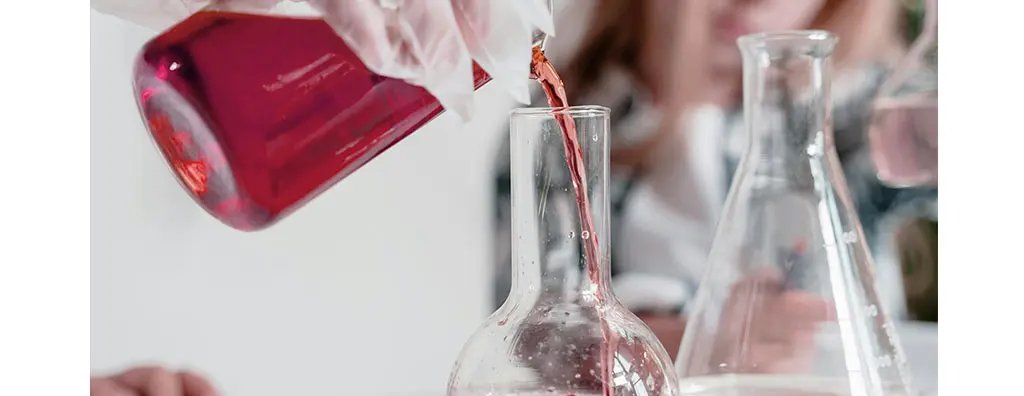 Pouring sauce into a glass flask