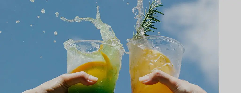 Two people toasting with beverage cocktails