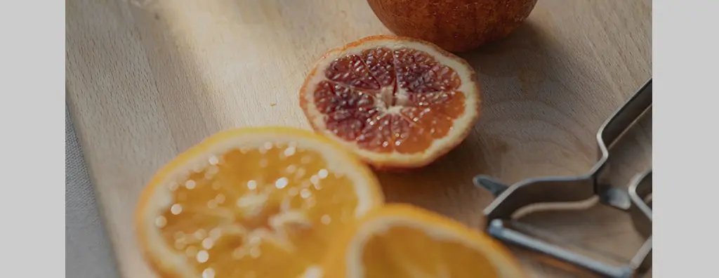 Three citrus fruits cut in half